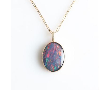 A black opal doublet pendant, set with an oval black opal doublet, measuring approx. 15x12mm, stamped 10k, on a fancy link be