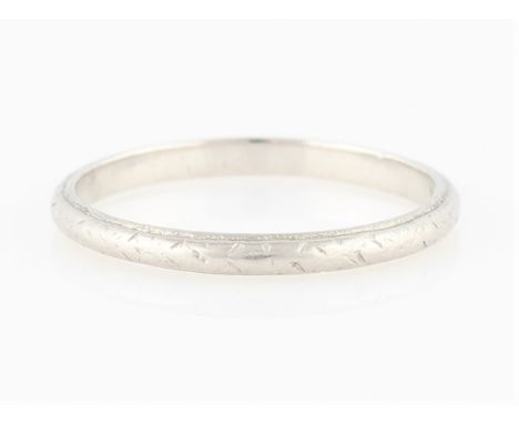 An engraved wedding band, white metal stamped PLATINUM, ring size M.