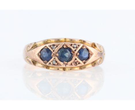 A hallmarked 9ct yellow gold sapphire and diamond ring, set with three graduated round cut sapphires and single cut diamond a