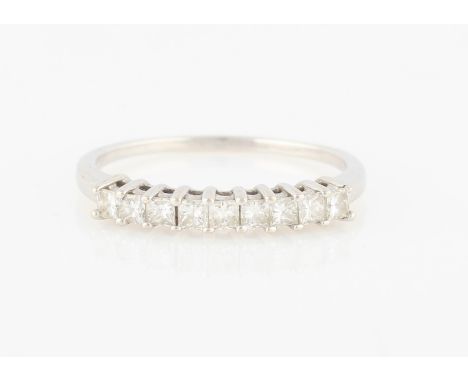 A diamond half eternity ring, set with nine princess cut diamonds, total diamond weight approx. 0.45ct, d stamped 18k, ring s