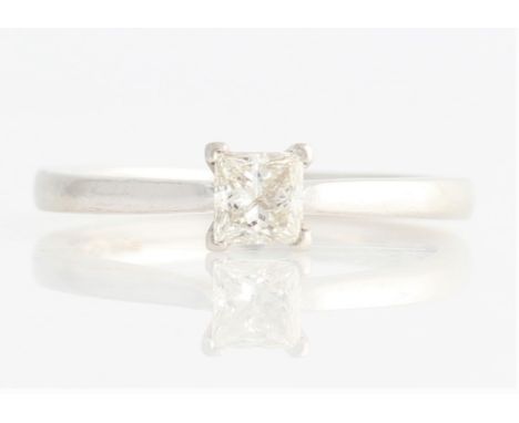 A hallmarked platinum diamond solitaire ring, set with a princess cut diamond, measuring approx. 0.32ct, to a plain band, rin