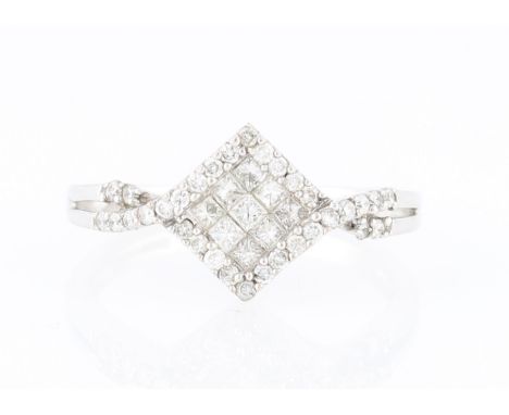 A hallmarked 18ct white gold diamond cluster ring, the square design set centrally with nine princess cut diamonds, surrounde