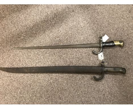 Two 19th Century French bayonets, one engraved with number 57610 and one with metal scabbard