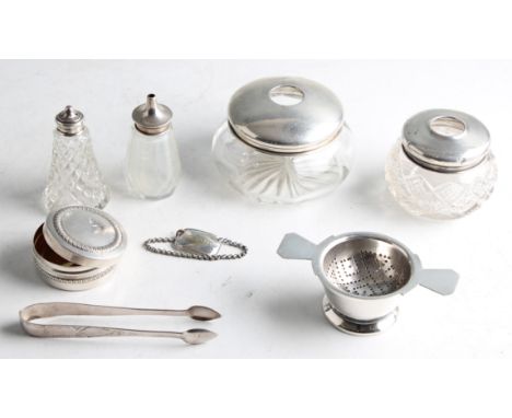 A collection to include two hallmarked silver lidded dressing table hair pots, a hallmarked silver lidded pepperette and salt