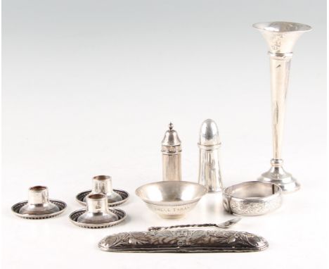 A collection of hallmarked silverware, to include a weighted bud vase, two pepperettes, a condiment spoon, a bangle, three ca