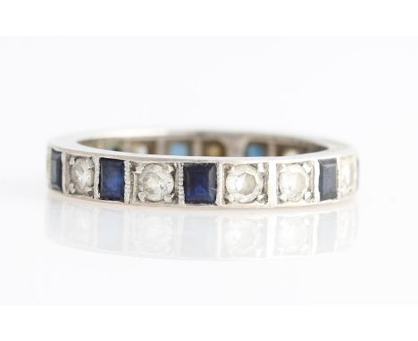 A sapphire and diamond full eternity ring, set with alternating eight-cut diamonds and square cut sapphires, unmarked white m