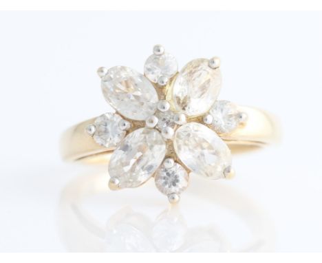 A hallmarked 9ct yellow gold colourless zircon flower design ring, set with oval and round cut colourless zircon, ring size N