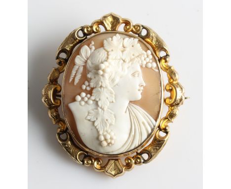 A cameo brooch, featuring the portrait of Bacchus, surrounded by a yellow metal frame with open metalwork engraved border and