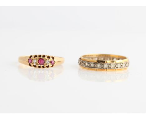 A lot to include, a hallmarked 18ct yellow gold ruby and diamond five stone ring and a paste full eternity ring, indistinctly