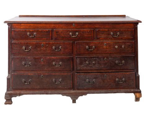 A oak mule chest, early 19th Century, the rectangular hinged moulded top enclosing a box interior with two small drawers to t