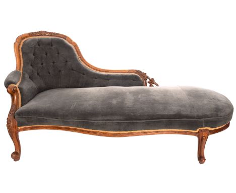 A Victorian carved walnut and upholstered chaise longue, circa 1870, the three quarter shaped and upholstered button down bac