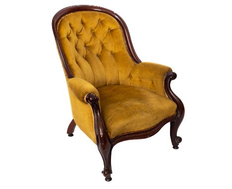 A Gentleman's Victorian mahogany armchair, circa 1860, with upholstered button down back, padded arm supports with carved scr