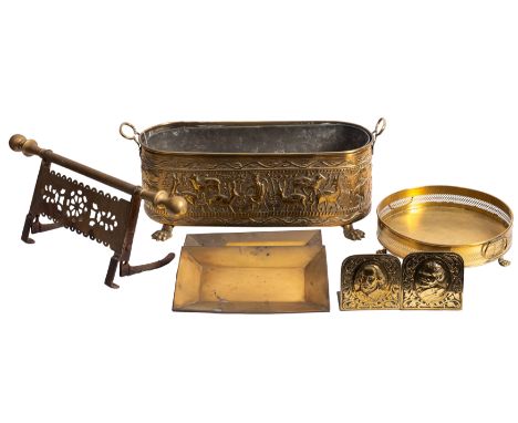 A Middle Eastern brass oblong planter, with looped handles and embossed figural and animal decoration, raised on lion paw fee