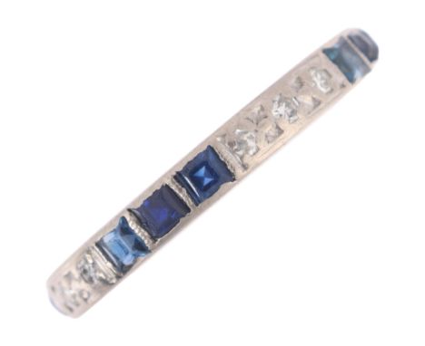 An Art Deco 18ct white gold (tested) sapphire and diamond full eternity ring, set with alternating trios of calibre-cut sapph