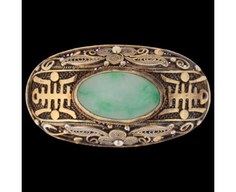 A Chinese silver-gilt jade bombe brooch, oval form with applied character marks on filigree wirework ground set with oval cab