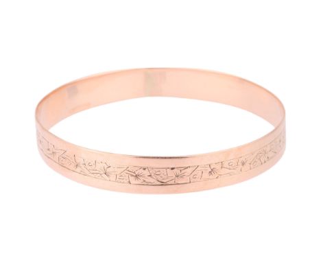 An Antique 9ct rose gold slave bangle, indistinct maker, floral engraved decoration, band width 11mm, internal circumference 