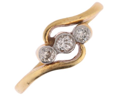 An 18ct gold three stone diamond crossover ring, maker TL, London 1979, setting height 7.3mm, size K, 2.3gNo damage or repair