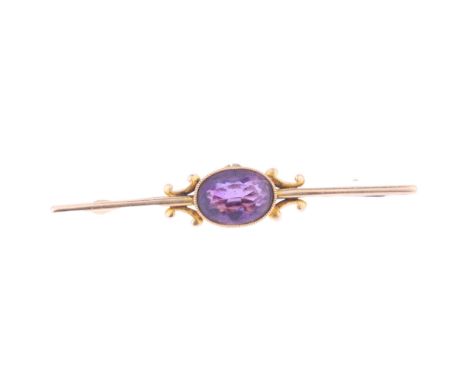 An Edwardian 15ct gold amethyst bar brooch, milgrain set with oval mixed-cut amethyst with floral engraved side panels, 52.1m