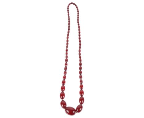 A long single-row graduated cherry amber bead necklace, beads measure 31.5-10.6mm, 80cm, 66.9gAll beads present, light surfac