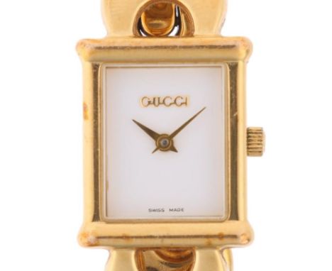 GUCCI - a lady's gold plated 1800L quartz bracelet watch, circa 1996, white dial with gilt lance hands and gold plated Gucci 