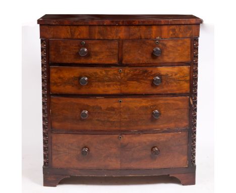 A VICTORIAN MAHOGANY BOW FRONT CHEST of two short and three long drawers with turned knob handles and raised on bracket feet 