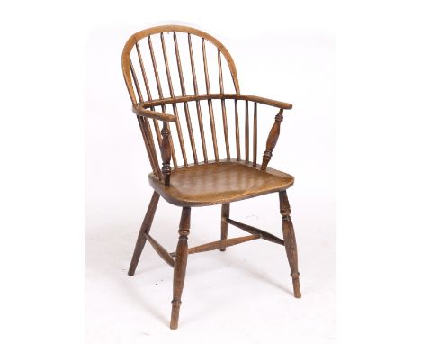 AN OLD ASH AND ELM WINDSOR STICK BACK ARMCHAIR with turned tapering legs 48cm wide