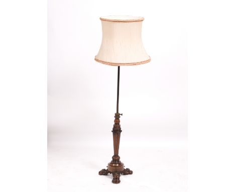 AN EARLY TO MID 19TH CENTURY ROSEWOOD ADJUSTABLE STANDARD LAMP with a reeded column support and three lion's paw feet
