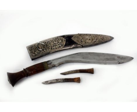 A WHITE METAL MOUNTED KUKRI KNIFE with flower decoration to the scabbard, 40cm long overall