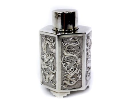 A CHINESE EXPORT HEXAGONAL WHITE METAL TEA CANISTER with chase and engraved decorations of dragons in panels and on bracket f