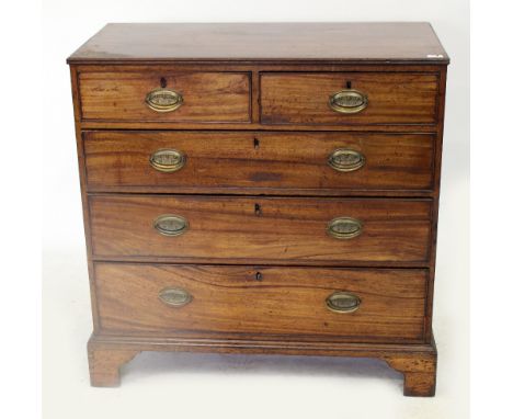 A 19TH CENTURY MAHOGANY CHEST  of two short and three long drawers standing on bracket feet, the brass handles decorated with