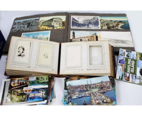 A COLLECTION OF VARIOUS POSTCARDS mid to late 20th century in date, together with a Victorian photograph album containing som