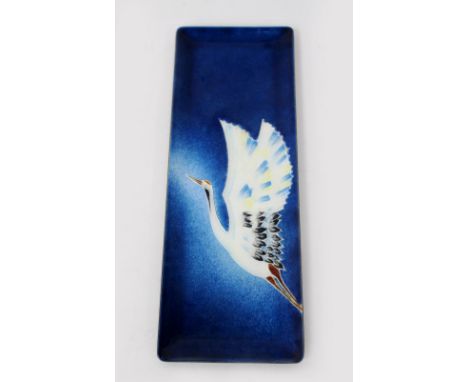 AN ENAMEL DECORATED RECTANGULAR TRAY with an image of a stork, 24cm wide 