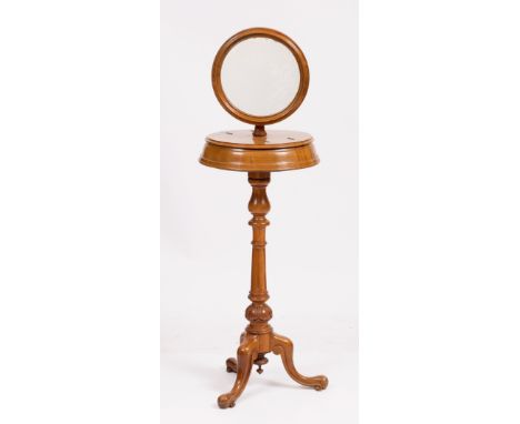 A VICTORIAN MAHOGANY SHAVING STAND with a circular mirror, fluted stem and a tripod base 43cm wide x 140cm high 