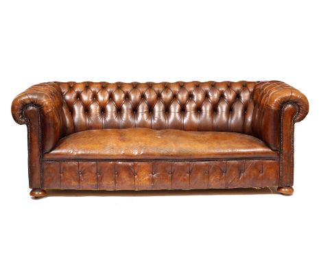 A BROWN LEATHER BUTTON UPHOLSTERED CHESTERFIELD SETTEE with turned bun feet and ceramic castors 204cm wide x 90cm deep x 73cm