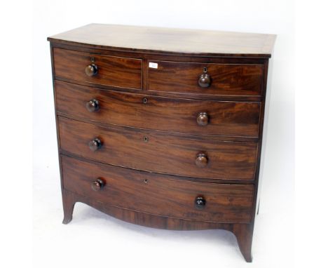 A 19TH CENTURY MAHOGANY BOW FRONTED CHEST OF TWO SHORT AND THREE LONG GRADUATED DRAWERS with turned knob handles and splayed 