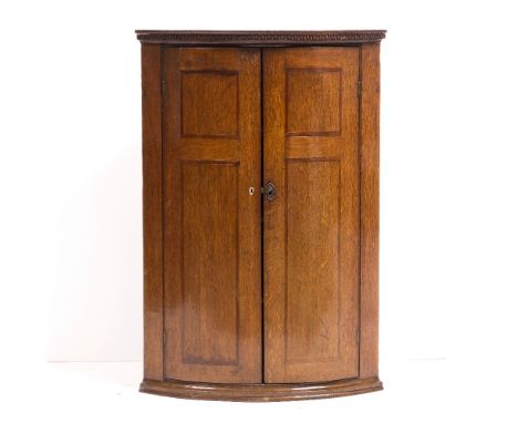 A 19TH CENTURY OAK BOW FRONTED CORNER CABINET 65cm wide x 53cm deep x 95cm high