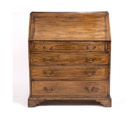 A GEORGE III MAHOGANY BUREAU  the fall front opening to reveal pigeon holes and drawers above four long drawers and with bras