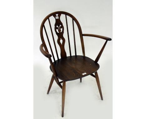 AN ERCOL SPINDLE BACK ARMCHAIR