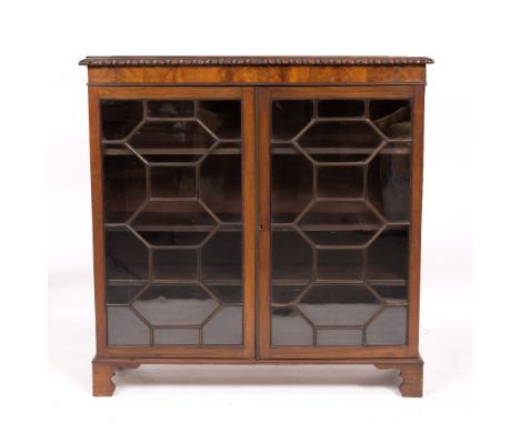 A LATE 19TH CENTURY MAHOGANY BOOKCASE CABINET with twin astragal glazed doors, opening to reveal three fixed shelves, all rai