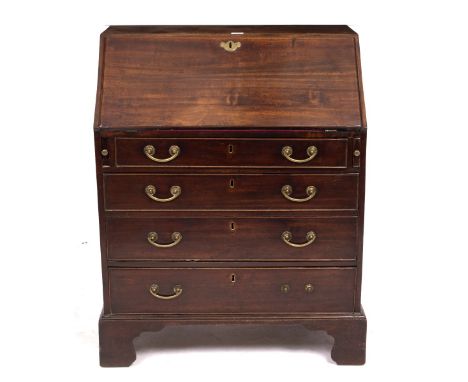A GEORGE III MAHOGANY BUREAU of small proportions with a fall front opening to reveal pigeon holes and drawers above four lon