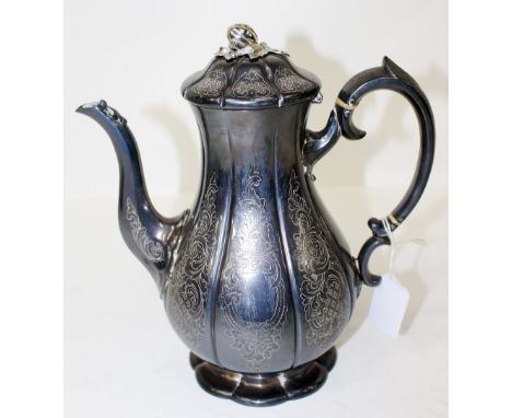 A VICTORIAN SILVER COFFEE POT of baluster form with scroll handle and gourd knop to the hinged lid, marks beneath for London 