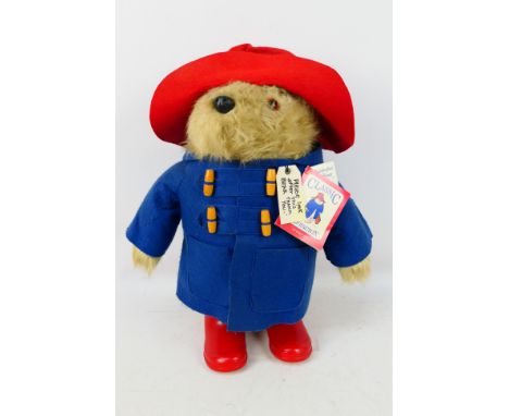 Eden, Paddington Bear - A free standing Paddington Bear approx 47 cm high. Comes with swing tag and wears a blue coat duffle 