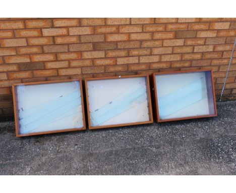 Three wooden display cabinets with glass shelves. Two of the cabinets measure approximately 62cms (L) x 49cms (H) x 9cms (D),