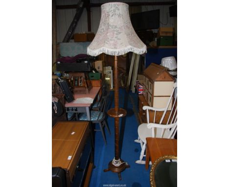 A wooden standard lamp and shade.