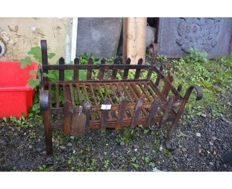 A cast iron fire grate,  23" long x 17 1/12" depth x 13 3/4" high.