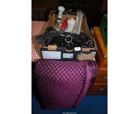 A purple throw, a leather handbag, table lamp, etc.