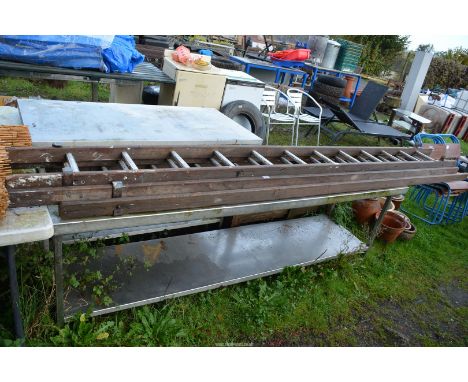 A three piece wooden extending ladder.