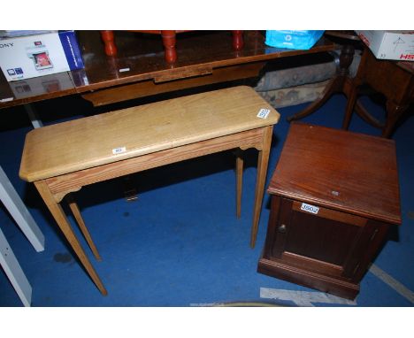 A light oak side table and a stained pine pot cupboard.