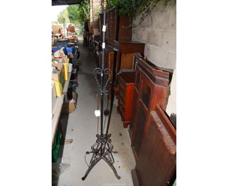 A metal floor standing lamp with scroll features, 63'' tall.