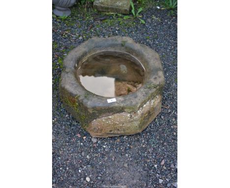 An octagonal stone planter, 20" diameter x 10" deep, possibly an early stone font, mortar or knocking stone.
